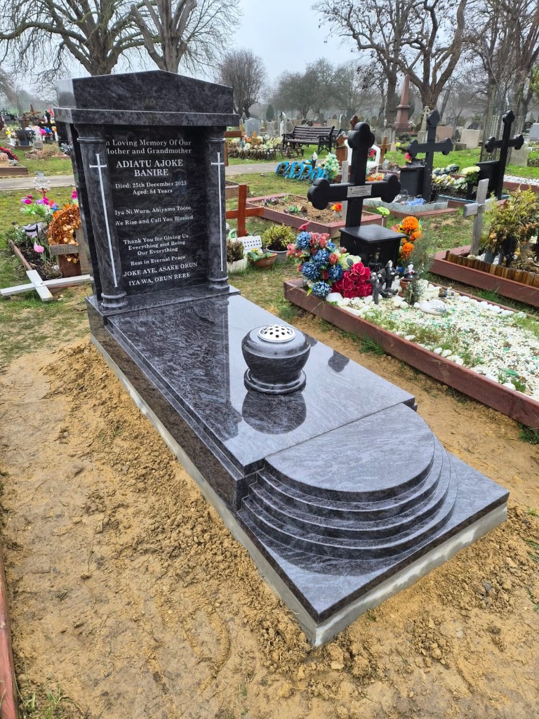 Polished dark granite full memorial with ledger slab, stone vase and stepped foot detail at Edmonton Cemetery, North London — memorial installation