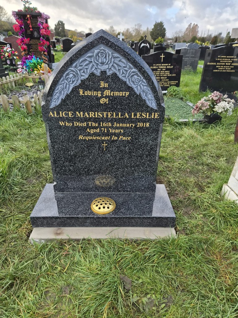 Elegant black granite lawn memorial with carved roses at Hither Green Cemetery, South East London - Professional memorial masonry